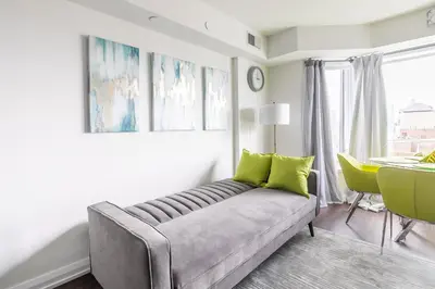 a living room with a couch and a table at Forest 1Bd & DEN in Yorkville 10 Floor in Toronto
