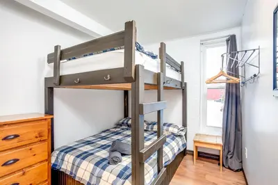 a bunk bed in a bedroom with a bunk bedutenewayeway at Happy Daze Big Space Near Village Hot Tub 38L-194 in Blue Mountains