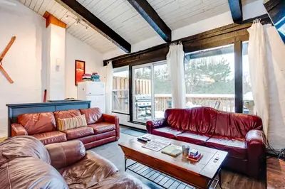 a living room with two leather couches and a table at Happy Daze Big Space Near Village Hot Tub 38L-194 in Blue Mountains