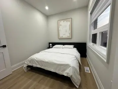 a bedroom with a bed and a window at Mins from Toronto Downtown UFT Exhibition Place in Toronto