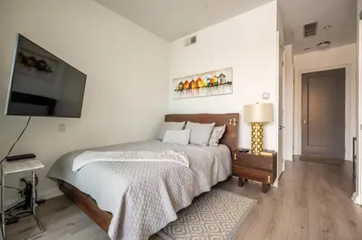 a bedroom with a bed and a flat screen tv at Gorgeous 1 Bedroom Apt with Balcony in Yorkville in Toronto