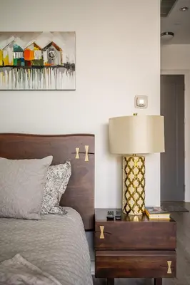 a bedroom with a bed and a table with a lamp at Gorgeous 1 Bedroom Apt with Balcony in Yorkville in Toronto
