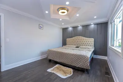 a bedroom with a bed and a window at Greate place with lot of rooms for relaxing in Toronto