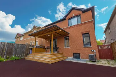 a brick house with a porch with a deck at Greate place with lot of rooms for relaxing in Toronto