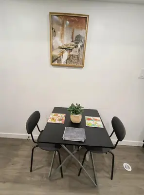 a black table with chairs and a plant on it at ArbyManie's Place Newly Built Basement Apartment in London