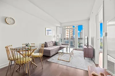 a living room with a couch and a table at Cozy 1 Bedroom Dunfield Ave in Toronto