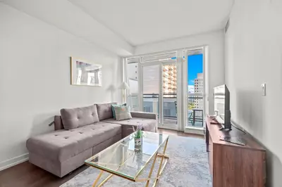 a living room with a couch and a glass table at Cozy 1 Bedroom Dunfield Ave in Toronto