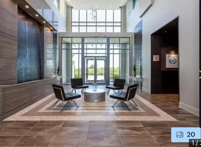 a lobby with chairs and a table in a building at Aseesniwas in Brampton