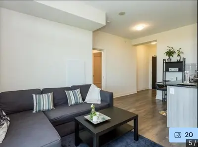 a living room with a couch and a table at Aseesniwas in Brampton