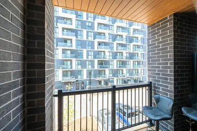 a balcony with a large building in the background at Modern Townhouse Rooftop Vibes in Oakville