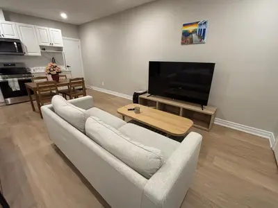 a living room with a white couch and a flat screen tv at Beautiful apartment DT Toronto in Toronto