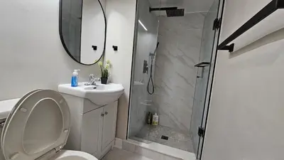 a bathroom with a shower and a toilet and a sink at Beautiful apartment DT Toronto in Toronto