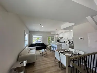 a living room and kitchen with a couch and a table at Downtown Toronto UFT in Toronto