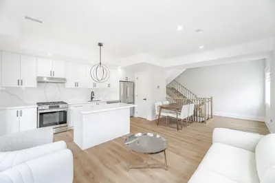 a white kitchen with a couch and a table at Downtown Toronto UFT in Toronto