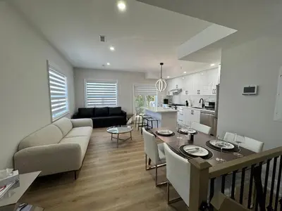 a kitchen and living room with a table and a couch at Downtown Toronto UFT in Toronto