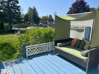 a bench on a deck with a gazebo at Beautiful Four Bedroom Lagoon City Waterfront Home in Brechin