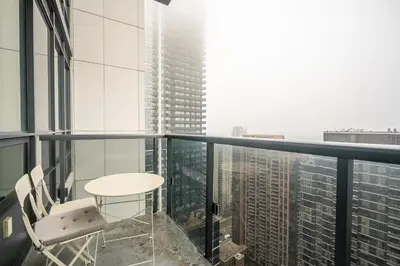 a balcony with a table and chairs on a skyscraper at Modern 1 BR Apartment in North York Free parking in Toronto