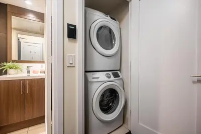 a kitchen with a washer and dryer in a room at Modern 1 BR Apartment in North York Free parking in Toronto