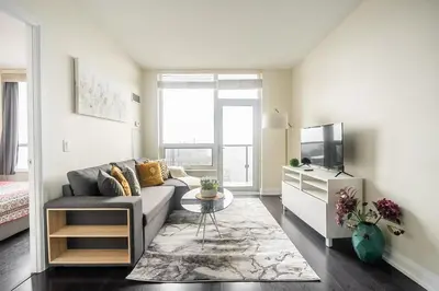 a living room with a couch and a tv at Modern 1 BR Apartment in North York Free parking in Toronto