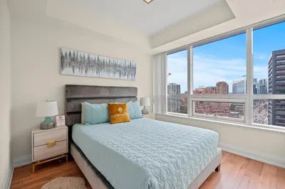 a bedroom with a bed and a large window at Amazing 1Bedroom 1BR Sheppard Metro Free parking in Toronto
