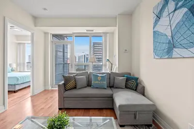 a living room with a couch and a glass table at Amazing 1Bedroom 1BR Sheppard Metro Free parking in Toronto