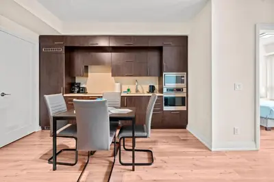 a kitchen and dining room with a table and chairs at Amazing 1Bedroom 1BR Sheppard Metro Free parking in Toronto
