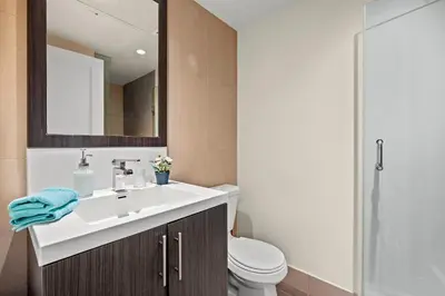 a bathroom with a white sink and a toilet at Amazing 1Bedroom 1BR Sheppard Metro Free parking in Toronto