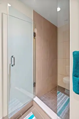 a shower with a glass door in a bathroom at Amazing 1Bedroom 1BR Sheppard Metro Free parking in Toronto
