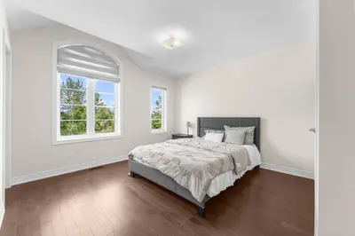 a white bedroom with a bed and a window at Heaven Beach House 2 min walk in Georgina