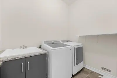 a washing machine and a sink in a room at Heaven Beach House 2 min walk in Georgina