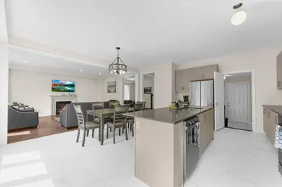 a kitchen and living room with a table and chairs at Heaven Beach House 2 min walk in Georgina