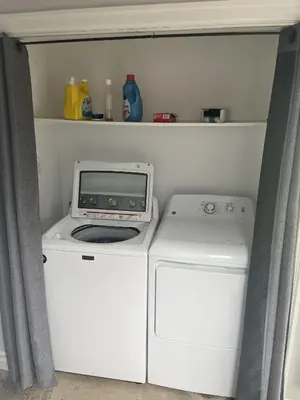 a washer and dryer in a small room with a washer at Fieldstone & Sky in Frankford