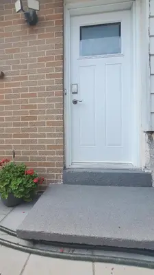 a white door to a brick house with a potted plant at Cozy Basement Stay in Mississauga in Mississauga