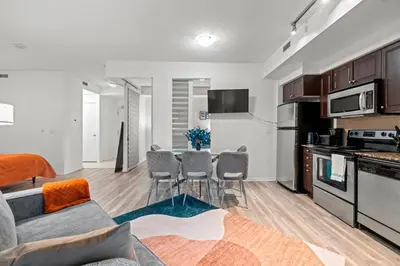 a kitchen and living room with a table and chairs at Superior 1Bd & DEN Apartment with Balcony in Toronto