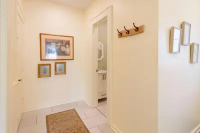 a hallway with a door leading into a bathroom with a mirror at Central Picton Apartment, Sleeps 8; The Iron Horse in Picton