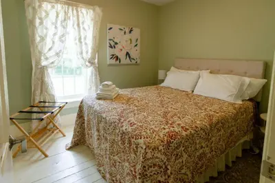 a bedroom with a large bed and a window at Central Picton Apartment, Sleeps 8; The Iron Horse in Picton
