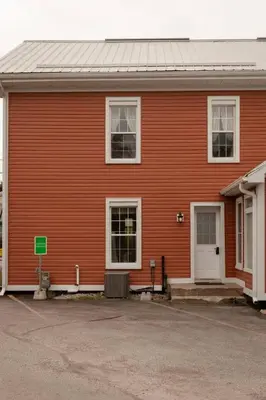 a red house with a white door and windows at Central Picton Apartment, Sleeps 8; The Iron Horse in Picton