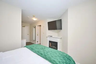 a bedroom with a bed and a fireplace at Nine Vines Hotel in Niagara on the Lake