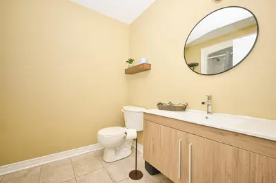 a bathroom with a sink and a toilet and a mirror at Nine Vines Hotel in Niagara on the Lake
