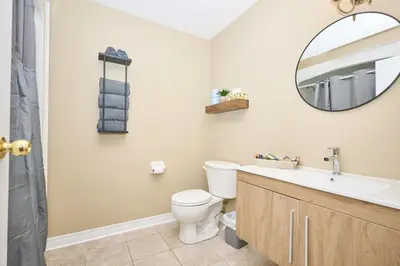a bathroom with a toilet and a sink and a mirror at Nine Vines Hotel in Niagara on the Lake