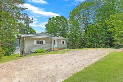 a home with a dirt road in front of a house at Muskoka Gem 8ppfireplacescanoekayaks in Bracebridge