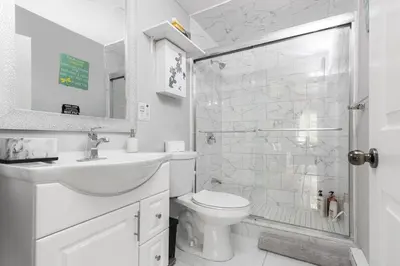a bathroom with a toilet and a sink and a shower at Muskoka Gem 8ppfireplacescanoekayaks in Bracebridge