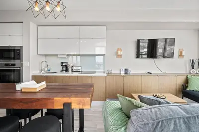 a kitchen and living room with a table and a couch at High Floor 1 Bedroom Condo Iceboat Terrace Downtown Toronto in Toronto
