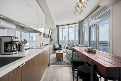 a kitchen and living room with a view of the city at High Floor 1 Bedroom Condo Iceboat Terrace Downtown Toronto in Toronto