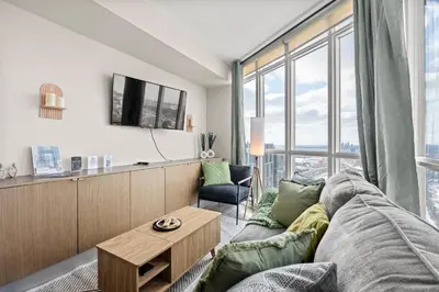 a living room with a couch and a table at High Floor 1 Bedroom Condo Iceboat Terrace Downtown Toronto in Toronto