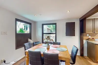 a dining room with a wooden table and chairs at Lazy Daze (House 2) in Wasaga Beach