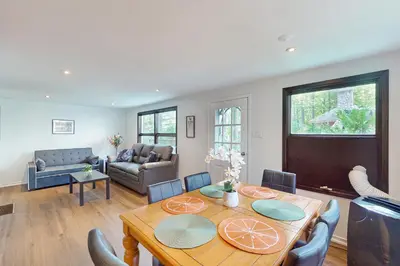 a living room with a wooden table and chairs at Lazy Daze (House 2) in Wasaga Beach