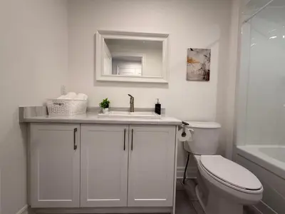 a white bathroom with a sink and a toilet at Upscale Niagara Falls Getaway - BRAND NEW in Niagara Falls