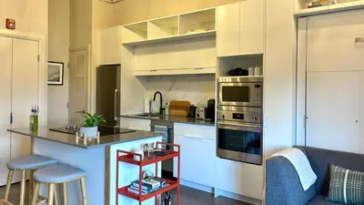 a kitchen with white cabinets and a counter top at The Artist's Loft in Stratford
