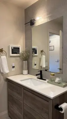 a bathroom with a sink and a large mirror at The Artist's Loft in Stratford